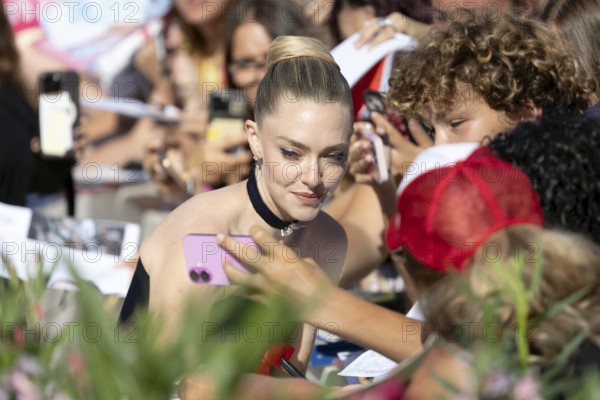 Venice, Italy - 1 September 2025: Amanda Seyfried signing autographs during the Red Carpet of - The Testament of Ann Lee - during the 82nd Venice International Film Festival