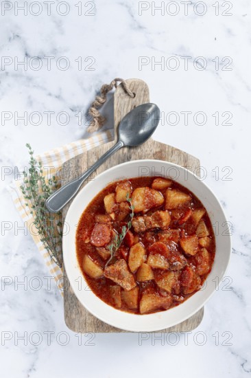 Meat goulash with potatoes and carrots, sweet peppers, in a saucepan, top view, traditional Hungarian soup, homemade, no people