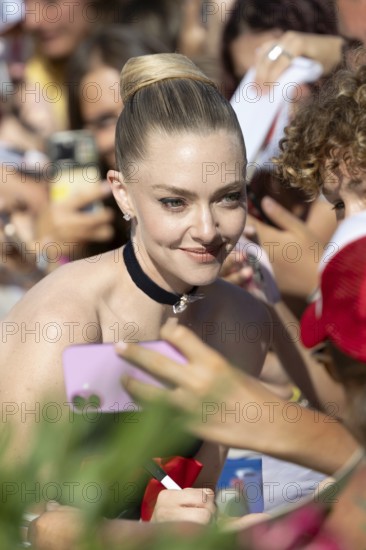 Venice, Italy - 1 September 2025: Amanda Seyfried signing autographs during the Red Carpet of - The Testament of Ann Lee - during the 82nd Venice International Film Festival