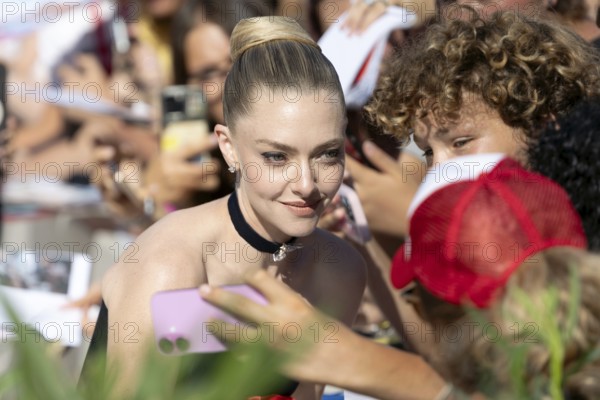 Venice, Italy - 1 September 2025: Amanda Seyfried signing autographs during the Red Carpet of - The Testament of Ann Lee - during the 82nd Venice International Film Festival