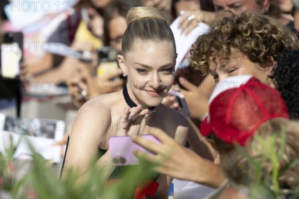 Venice, Italy - 1 September 2025: Amanda Seyfried signing autographs during the Red Carpet of - The Testament of Ann Lee - during the 82nd Venice International Film Festival