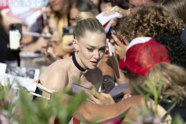 Venice, Italy - 1 September 2025: Amanda Seyfried signing autographs during the Red Carpet of - The Testament of Ann Lee - during the 82nd Venice International Film Festival