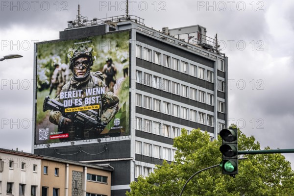 Large-format advertising poster of the German Armed Forces, for recruitment, on a residential building in Essen, on Viehofer Platz, North Rhine-Westphalia, Germany