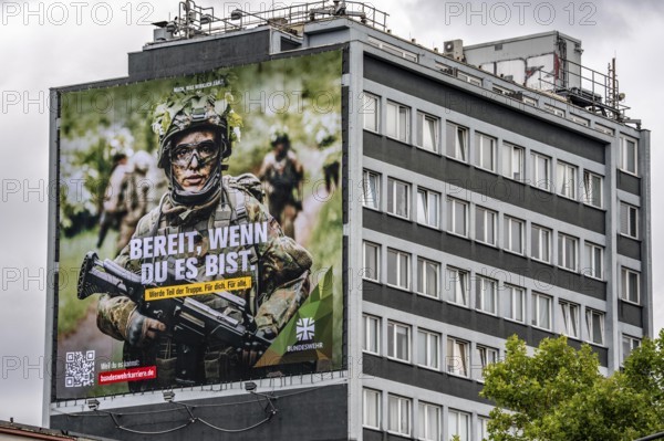 Large-format advertising poster of the German Armed Forces, for recruitment, on a residential building in Essen, on Viehofer Platz, North Rhine-Westphalia, Germany