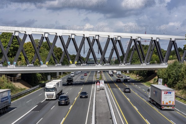 The new railway bridge over the A1 motorway at the Dortmund-Unna motorway junction, steel truss bridge, weighing 2000 tonnes, 124 metre span, new construction due to the widening of the A1 in this area, regional trains, ICE trains and goods trains run here between Dortmund and Soest, North Rhine-Westphalia, Germany