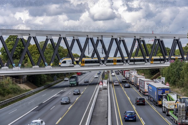 The new railway bridge over the A1 motorway at the Dortmund-Unna motorway junction, steel truss bridge, weighing 2000 tonnes, 124 metre span, new construction due to the widening of the A1 in this area, regional trains, ICE trains and goods trains run here between Dortmund and Soest, North Rhine-Westphalia, Germany
