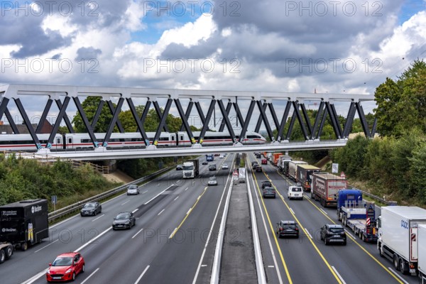 The new railway bridge over the A1 motorway at the Dortmund-Unna motorway junction, steel truss bridge, weighing 2000 tonnes, 124 metre span, new construction due to the widening of the A1 in this area, regional trains, ICE trains and goods trains run here between Dortmund and Soest, North Rhine-Westphalia, Germany