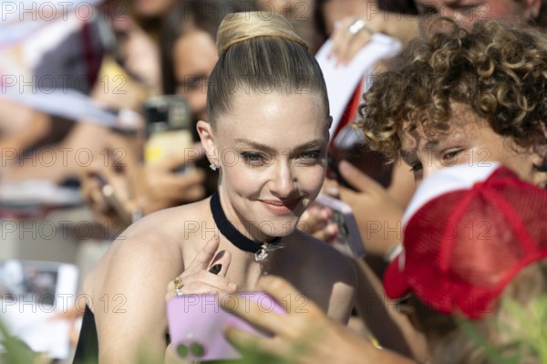 Venice, Italy - 1 September 2025: Amanda Seyfried signing autographs during the Red Carpet of - The Testament of Ann Lee - during the 82nd Venice International Film Festival