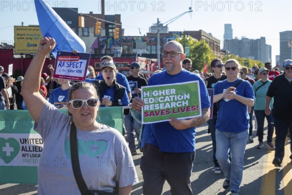 Detroit, Michigan USA - 1 September 2025 - Members of the American Federation of Teachers march in Detroit's Labor Day parade. They were campaigning to save higher education research funding, which has been under attack by the Trump administration