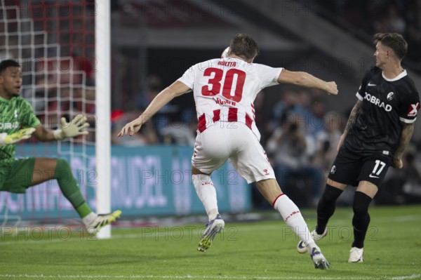 (DFL/DFB REGULATES PROHIBIT ANY USE OF PHOTOGRAPHS AS IMAGE SEQUENCES AND/OR QUASI-VIDEO), RheinEnergieStadion, Cologne, North Rhine-Westphalia, Alexander Schwolow (SC Freiburg, Goalkeeper, #1), Marius Bülter (1.FC Köln, Forward, #30), 1st Bundesliga, 1.FC Köln, SC Freiburg on 31.08.2025 at the RheinEnergieStadion in Cologne Germany