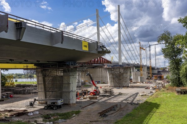 New construction of the second motorway bridge Neuenkamp of the A40, over the Rhine near Duisburg, parallel to the already existing first bridge, most of the new bridge piers are in place, two first bridge segments are finished and have already been moved towards the river on both sides of the Rhine, full completion is planned for 2028, North Rhine-Westphalia, Germany