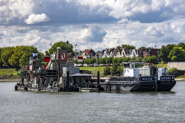 Bucket chain dredger at work on the Rhine near Duisburg, between the Neuenkamper Rhine Bridge and the Friedrich-Ebert Bridge in Ruhrpott, dredging the navigation channel, North Rhine-Westphalia, Germany