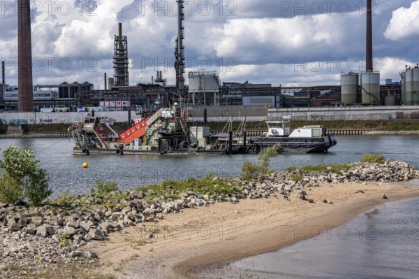 Bucket chain dredger at work on the Rhine near Duisburg, between the Neuenkamper Rhine Bridge and the Friedrich-Ebert Bridge in Ruhrpott, dredging the navigation channel, North Rhine-Westphalia, Germany