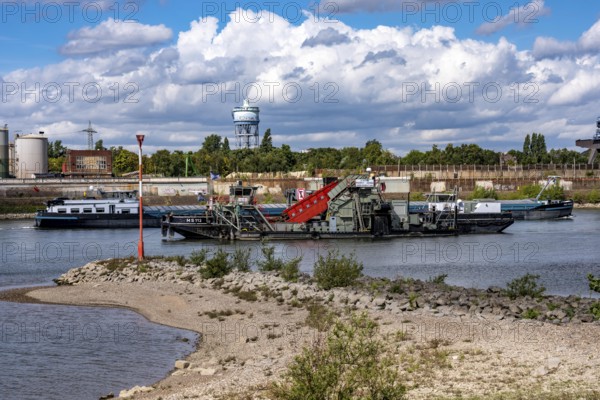 Bucket chain dredger at work on the Rhine near Duisburg, between the Neuenkamper Rhine Bridge and the Friedrich-Ebert Bridge in Ruhrpott, dredging the navigation channel, North Rhine-Westphalia, Germany