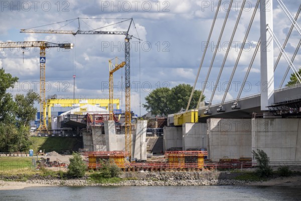 New construction of the second motorway bridge Neuenkamp of the A40, over the Rhine near Duisburg, parallel to the already existing first bridge, most of the new bridge piers are in place, two first bridge segments are finished and have already been moved towards the river on both sides of the Rhine, full completion is planned for 2028, North Rhine-Westphalia, Germany