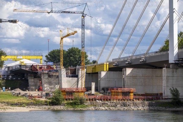 New construction of the second motorway bridge Neuenkamp of the A40, over the Rhine near Duisburg, parallel to the already existing first bridge, most of the new bridge piers are in place, two first bridge segments are finished and have already been moved towards the river on both sides of the Rhine, full completion is planned for 2028, North Rhine-Westphalia, Germany