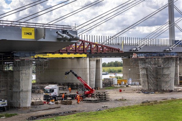 New construction of the second motorway bridge Neuenkamp of the A40, over the Rhine near Duisburg, parallel to the already existing first bridge, most of the new bridge piers are in place, two first bridge segments are finished and have already been moved towards the river on both sides of the Rhine, full completion is planned for 2028, North Rhine-Westphalia, Germany