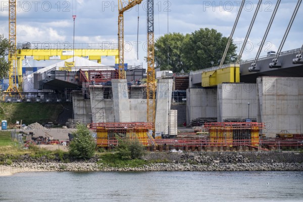 New construction of the second motorway bridge Neuenkamp of the A40, over the Rhine near Duisburg, parallel to the already existing first bridge, most of the new bridge piers are in place, two first bridge segments are finished and have already been moved towards the river on both sides of the Rhine, full completion is planned for 2028, North Rhine-Westphalia, Germany