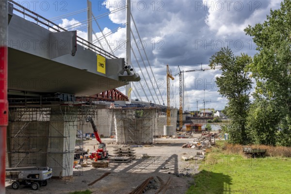 New construction of the second motorway bridge Neuenkamp of the A40, over the Rhine near Duisburg, parallel to the already existing first bridge, most of the new bridge piers are in place, two first bridge segments are finished and have already been moved towards the river on both sides of the Rhine, full completion is planned for 2028, North Rhine-Westphalia, Germany