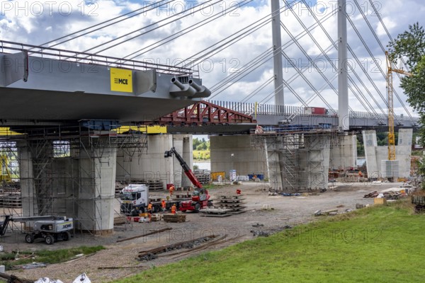 New construction of the second motorway bridge Neuenkamp of the A40, over the Rhine near Duisburg, parallel to the already existing first bridge, most of the new bridge piers are in place, two first bridge segments are finished and have already been moved towards the river on both sides of the Rhine, full completion is planned for 2028, North Rhine-Westphalia, Germany