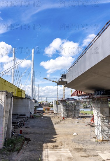 New construction of the second motorway bridge Neuenkamp of the A40, over the Rhine near Duisburg, parallel to the already existing first bridge, most of the new bridge piers are in place, two first bridge segments are finished and have already been moved towards the river on both sides of the Rhine, full completion is planned for 2028, North Rhine-Westphalia, Germany