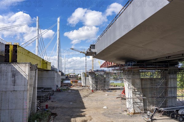New construction of the second motorway bridge Neuenkamp of the A40, over the Rhine near Duisburg, parallel to the already existing first bridge, most of the new bridge piers are in place, two first bridge segments are finished and have already been moved towards the river on both sides of the Rhine, full completion is planned for 2028, North Rhine-Westphalia, Germany