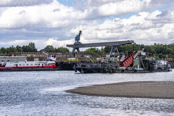 Bucket chain dredger at work on the Rhine near Duisburg, between the Neuenkamper Rhine Bridge and the Friedrich-Ebert Bridge in Ruhrpott, dredging the navigation channel, North Rhine-Westphalia, Germany