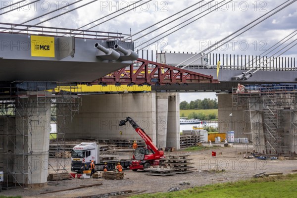 New construction of the second motorway bridge Neuenkamp of the A40, over the Rhine near Duisburg, parallel to the already existing first bridge, most of the new bridge piers are in place, two first bridge segments are finished and have already been moved towards the river on both sides of the Rhine, full completion is planned for 2028, North Rhine-Westphalia, Germany