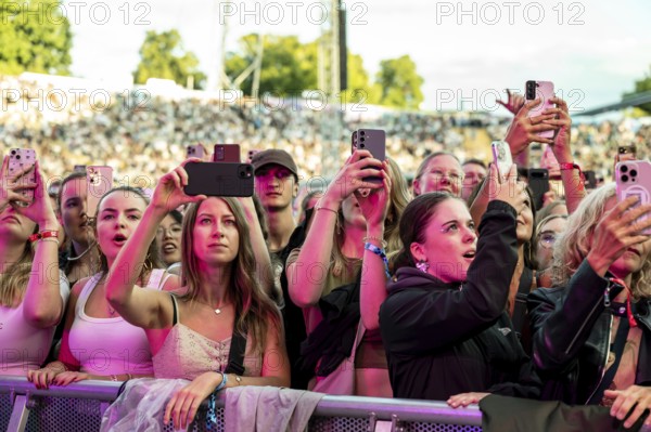 Visitors film the performance of Nelly Furtado with their mobile phones at the Superbloom Festival, Day 1 at the Olympiapark, Munich, 30.08.2025