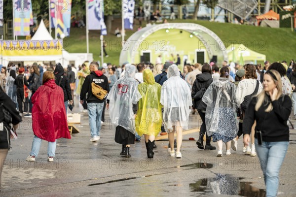 Festival visitors with rain capes at the Superbloom Festival, Day 1 in the Olympic Park, Munich, 30/08/2025