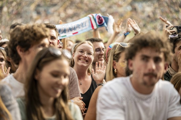 Visitor waving into camera at the Superbloom Festival, Day 1 in the Olympic Park, Munich, 30/08/2025