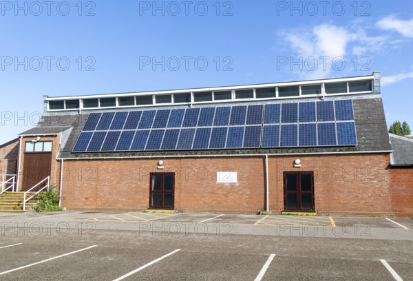 Solar panels on roof of Woodbridge Community Hall, community centre building, Woodbridge, Suffolk, England, UK