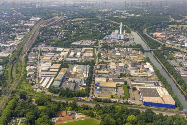Aerial view, commercial area Buschhausener Straße at the Rhine-Herne-Canal, behind GMVA Niederrhein GmbH (joint waste incineration plant) with chimney, Oberhausen, Ruhr area, North Rhine-Westphalia, Germany, DE, Europe, commercial enterprises, commercial area, commercial property, commercial park, commercial location, commercial use, industrial area, industrial location, aerial photograph, aerial photography, aerial photography, overview, bird's-eye view, overview, OberhausenSued