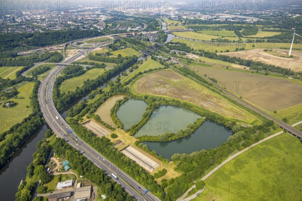 Aerial view, Große Ruhrinsel Klärschlammdeponie am Schifffahrtskanal der Ruhr, motorway A40 and Ruhrbrücke, behind the motorway junction Kaiserberg, railway tracks and railway bridges Brückenlandschaft Ruhraue, Oberhausen, Ruhr area, North Rhine-Westphalia, Germany, DE, landfill, Europe, aerial view, aerial photography, aerial photography, overview, bird's-eye view, overview, OberhausenSued