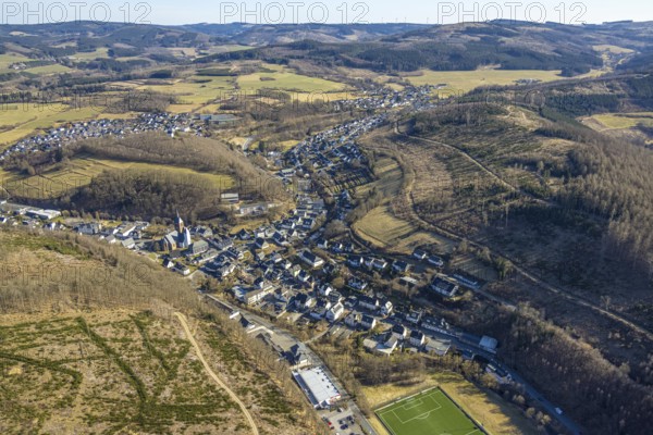 Aerial view, residential area local view, wooded area hilly landscape with forest damage, Church of St. Peter and Paul, Kirchhundem, Sauerland, North Rhine-Westphalia, Germany, place of worship, DE, Europe, place of worship, property tax, holy place, real estate, church, parish, aerial photograph, aerial photography, aerial photography, religion, overview, bird's-eye view, residential complex, living and life, residential area, residential quality, residential neighbourhood, housing estate, residential area, bird's-eye view, overview