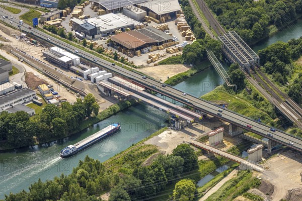 Aerial view, construction site with new construction, railway bridge Emscherbrücke Rollbahn, motorway A43 with bridge over Rhine-Herne Canal, Baukau, Herne, Ruhr area, North Rhine-Westphalia, Germany, A43, architecture, motorway, construction work, construction area, construction site, construction sites, Baukau-West, construction measure, construction project, construction site, construction site vehicles, bridge, bridge construction, DE, railway bridge, Emscherbrücke, Europe, river, water, large construction site, industry, industrial site, infrastructure, infrastructure project, canal, construction, landscape, aerial view, aerial photography, aerial photography, metal processing, Rhine-Herne Canal, runway, Ruhr area scene, rail, sinter works, city, road, transport, overview, urban, traffic, bird's-eye view, birds-eyes view, modern architecture, overview, linksderA43, HernelinksderA43