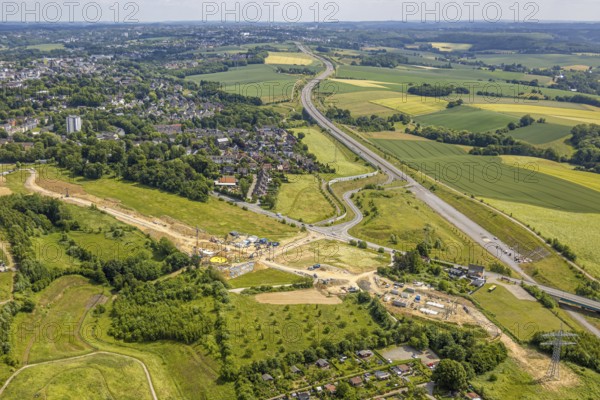 Aerial view, construction site new motorway construction section of the A44, gap closure between Ratingen-Ost and Velbert, construction site with construction crane In der Leibeck corner Ratinger Straße, Hofermühle, Heiligenhaus, Ruhr area, North Rhine-Westphalia, Germany, A44, Angerbachtalbrücke, Angertal, architecture, motorway, motorway bridge, construction work, construction area, construction site, building plots, construction measure, construction project, construction site, construction, bridge construction, DE, development, Europe, industry, infrastructure, infrastructure project, sewage treatment plant, landscape, aerial view, aerial photography, aerial photography, gap closure, new construction, new construction section, Ratingen-Ost, region, regional development, city view, road construction, technology, transport, overview, environment, Velbert, traffic, traffic routes, bird's eye view, birds-eyes view, modern, overview