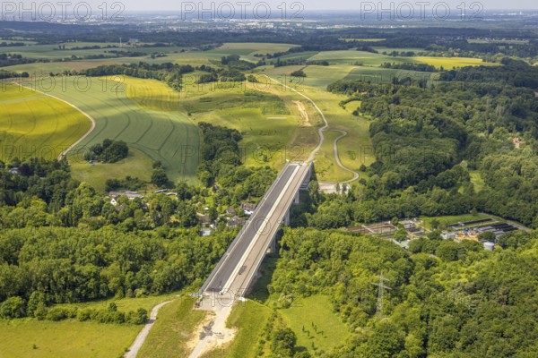 Aerial view, construction site Angerbachtalbrücke, new motorway construction section of the A44, gap closure between Ratingen-Ost and Velbert, sewage treatment plant Angertal, Heiligenhaus, Ruhr area, North Rhine-Westphalia, Germany, A44, Angerbachtalbrücke, Angertal, architecture, motorway, motorway bridge, construction work, construction area, construction site, building site, building plots, construction project, construction site, construction industry, bridge construction, DE, development, Europe, industry, infrastructure, infrastructure project, sewage treatment plant, landscape, aerial view, aerial photography, aerial photography, gap closure, new construction, new construction section, Ratingen-Ost, region, regional development, city view, road construction, technology, transport, overview, surroundings, Velbert, traffic, traffic routes, bird's-eye view, birds-eyes view, modern, overview