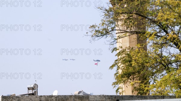 Türkiye special operations police hang from a helicopter with ropes, carrying weapons and unfurling a large Turkish flag while saluting citizens during an aerobatic air show at Teknofest technology festival. Gaziantep, Türkiye. September 24, 2020, Gaziantep, Gaziantep, Türkiye