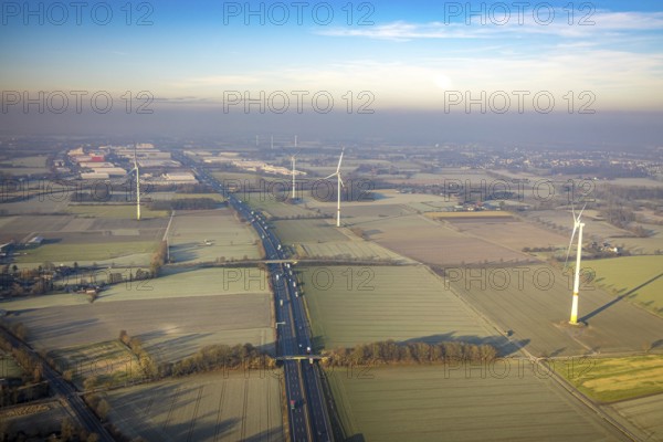 Aerial view, motorway A2, meadows and fields with wind turbines, distant view to the industrial area Weetfelder Straße with haze, district Rhynern, Hamm, Ruhr area, North Rhine-Westphalia, Germany