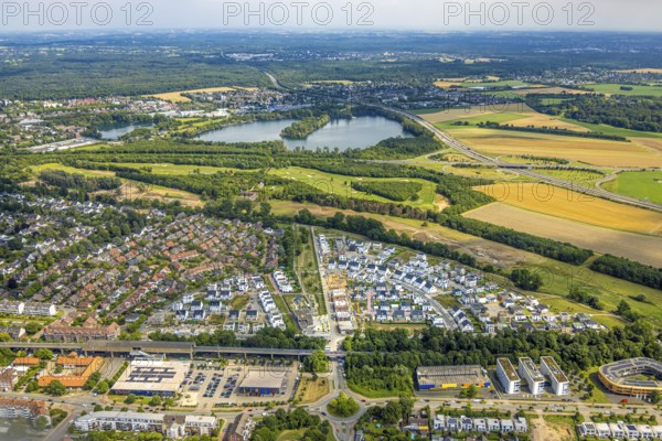 Aerial view, Duisburg-Süd, residential area Angerbogen, Am Alten Angerbach, semi-circular new housing estate, commercial area Xella International GmbH and Edeka E-Center Angerbogen, roofed railway station Angerbogen, behind the Rahmer See, Huckingen, Duisburg, Ruhr area, North Rhine-Westphalia, Germany, Ruh