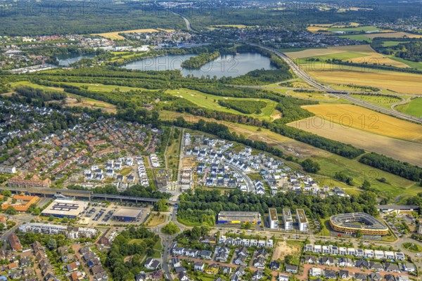 Aerial view, Duisburg-Süd, residential area Angerbogen, Am Alten Angerbach, semi-circular new housing estate, commercial area Xella International GmbH and Edeka E-Center Angerbogen, roofed railway station Angerbogen, behind the Rahmer See, Huckingen, Duisburg, Ruhr area, North Rhine-Westphalia, Germany, Ruh
