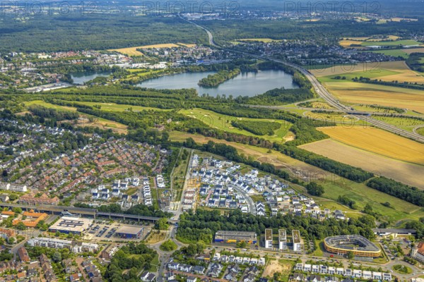 Aerial view, Duisburg-Süd, residential area Angerbogen, Am Alten Angerbach, semi-circular new housing estate, commercial area Xella International GmbH and Edeka E-Center Angerbogen, roofed railway station Angerbogen, behind the Rahmer See, Huckingen, Duisburg, Ruhr area, North Rhine-Westphalia, Germany, Ruh