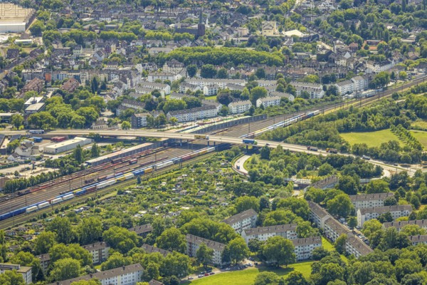 Aerial view, railway line with container site and bridge Friedrich-Ebert-Straße with curved road Zum Logport, tenement houses housing estate between Kruppstraße and Kronprinzenstraße, allotment garden site Zur Bahn, Friemersheim, Duisburg, Ruhr area, North Rhine-Westphalia, Germany, railway tracks, bridge, DE, railway tracks, Europe, community garden, allotment garden, allotment garden site, allotment garden association, allotment gardener association, allotment garden colony, aerial view, aerial photography, aerial photography, allotment garden, overview, bird's eye view, birds-eyes view, overview
