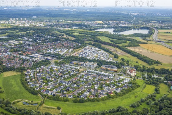 Aerial view, Duisburg-Süd, residential area Angerbogen, Am Alten Angerbach, semi-circular new housing estate, commercial area Xella International GmbH and Edeka E-Center Angerbogen, roofed railway station Angerbogen, behind the Rahmer See, Huckingen, Duisburg, Ruhr area, North Rhine-Westphalia, Germany