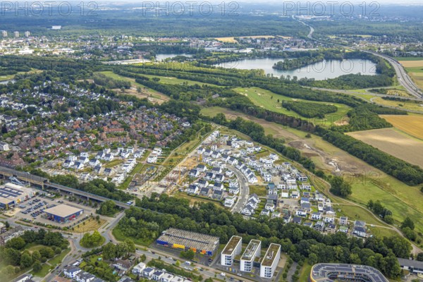 Aerial view, Duisburg-Süd, residential area Angerbogen, Am Alten Angerbach, semi-circular new housing estate, commercial area Xella International GmbH and Edeka E-Center Angerbogen, roofed railway station Angerbogen, behind the Rahmer See, Huckingen, Duisburg, Ruhr area, North Rhine-Westphalia, Germany