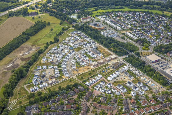 Aerial view, Duisburg-Süd, residential area Angerbogen, Am Alten Angerbach, semi-circular new housing estate, commercial area Xella International GmbH and Edeka E-Center Angerbogen, roofed railway station Angerbogen, behind the Rahmer See, Huckingen, Duisburg, Ruhr area, North Rhine-Westphalia, Germany
