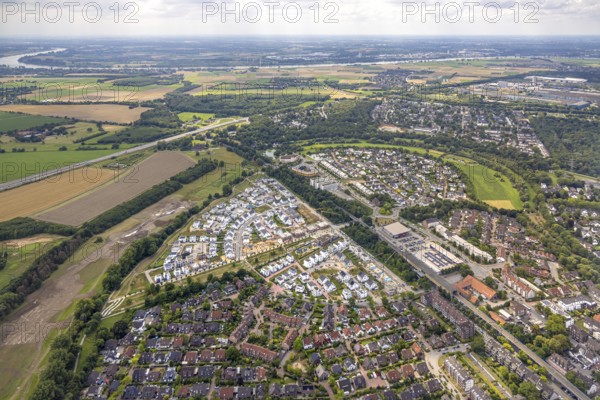 Aerial view, Duisburg-Süd, residential area Angerbogen, Am Alten Angerbach, semi-circular new housing estate, commercial area Xella International GmbH and Edeka E-Center Angerbogen, roofed railway station Angerbogen, behind the Rahmer See, Huckingen, Duisburg, Ruhr area, North Rhine-Westphalia, Germany