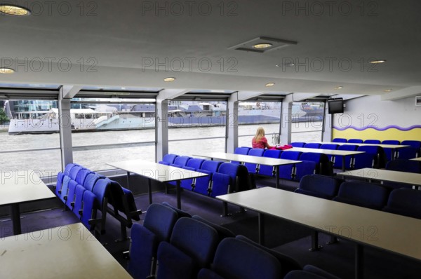 London, England, Great Britain, Europe, Interior of a boat with empty seats and view of the river