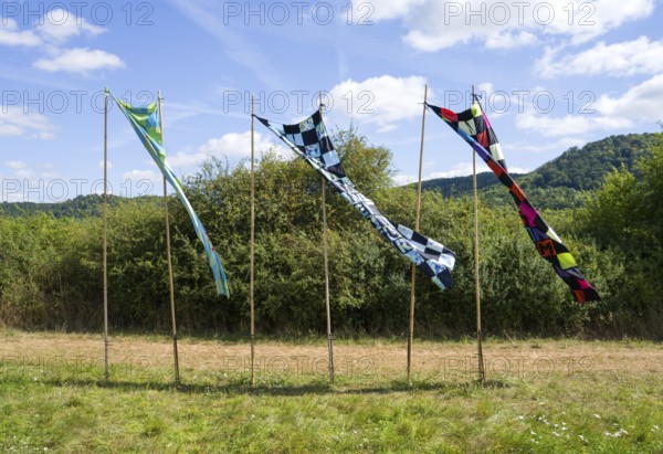 Objects Freiheitsfahnen, Freiheit ist kein Selbstläufer, Freiheit ist nie ohne Risiko, Freiheit muss man sich nehmen, Freedom flags, freedom is not self-perpetuating, freedom is never without risk, freedom you have to take, by Christiane Ten Hoevel, 12th international wind art festival 2025, landscape exhibition bewegter wind, Zierenberg, Northern Hesse, Germany